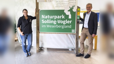 Claudia Wolff, Geschäftsführerin des Naturparks, und Verbandsvorsitzender Ralf Buberti präsentieren eines der neuen Naturparkeingangsschilder. (Foto: Naturpark Solling-Vogler)